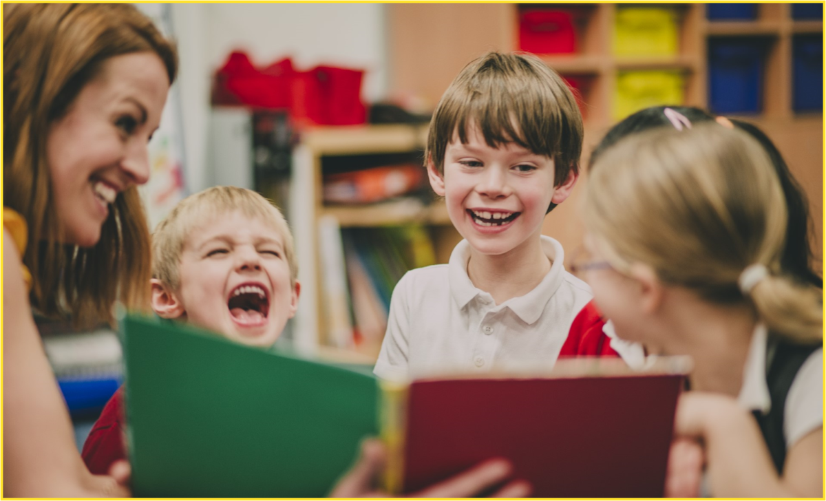 A female Librarian reading to four smiling kids
